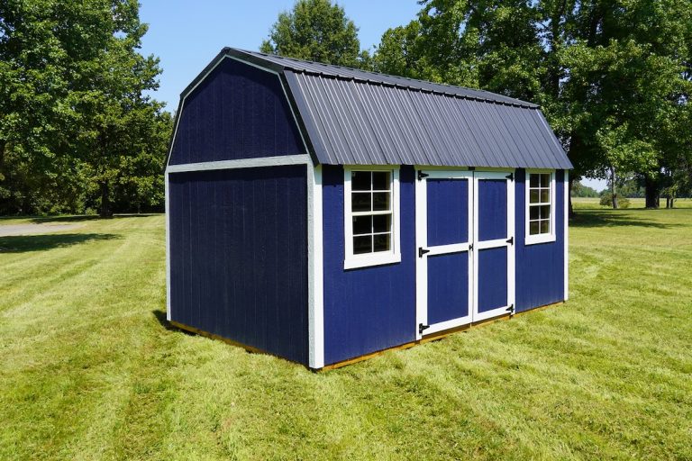 A striking Navy blue Premier Side Lofted Barn shed with white trim and a dark metal roof, featuring double doors and two windows on a lush green lawn under a clear sky.