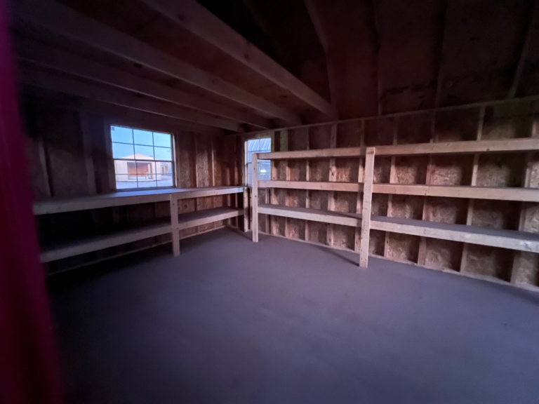 Premier Portable Building interior with a workbench and three tier shelving